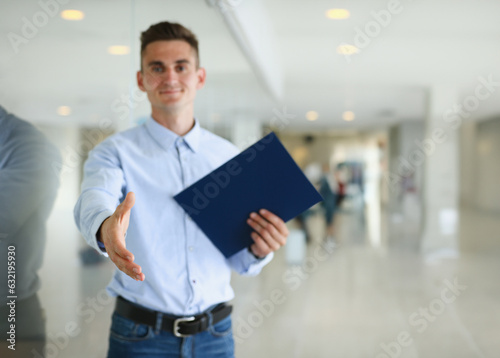 Businessman offer hand to shake as hello in office closeup. Serious business friendly support service excellent prospect introduction or thanks gesture gratitude invite to participate concept