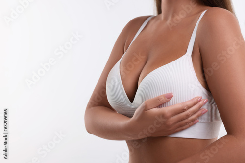 Woman with beautiful breast on white background, closeup. Space for text