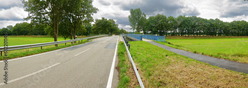 Bridge over a dry emergency flood passage along River Vecht in Laar, Lower Saxony, Germany, near the Netherlands border.  photo