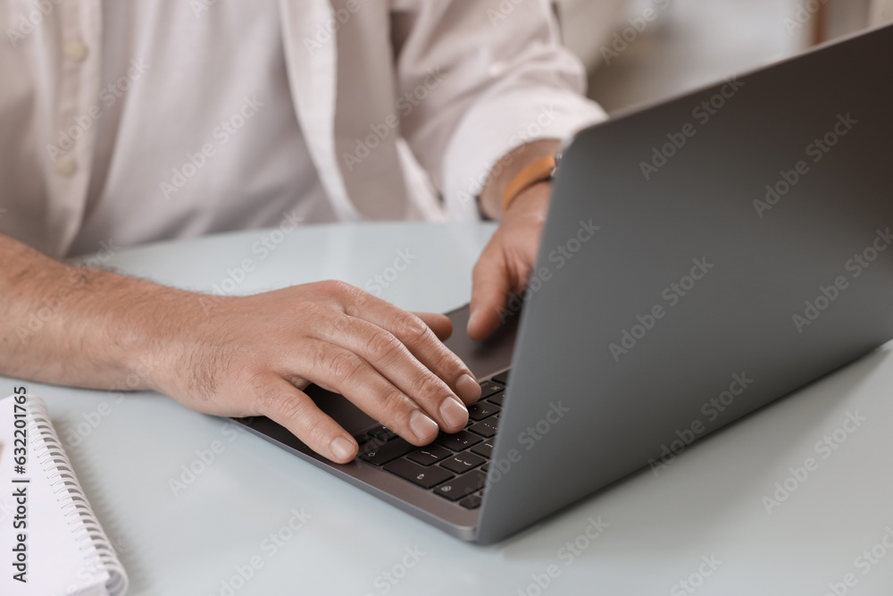 Man using modern laptop at table in cafe, closeup Man using modern laptop at table in cafe, closeup
