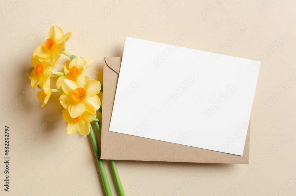 Blank greeting card mockup with envelope and daffodils flowers Blank greeting card mockup with envelope and daffodils flowers
