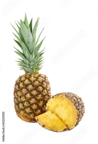 Whole and cut tasty ripe pineapples isolated on white