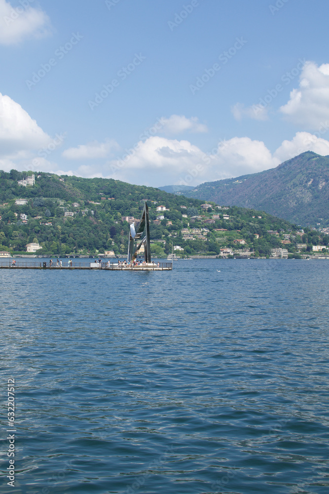 landscape of Como Lake with its port and surrounded with green mountains