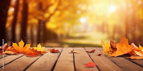 Beautiful colorful natural autumn background for presentation. Fallen dry orange leaves on wooden boards against the backdrop of a blurry autumn park