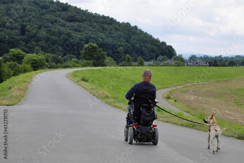 A disabled person spends his free time actively, enjoying the beautiful weather and wonderful views. Tyniec area. Poland