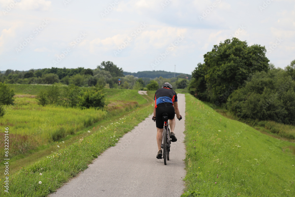 Cyclists on a bike path near Tyniec, Poland. Actively spending time outdoors