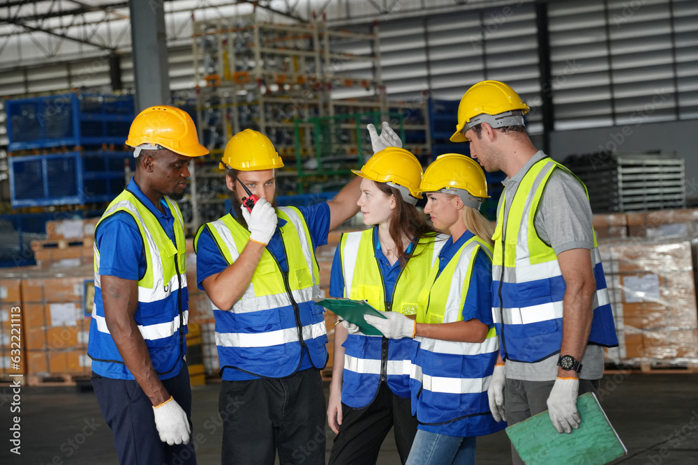 Team of warehouse employees working on inventory in a large distribution warehouse. Business factory industry concept. Team of warehouse employees working on inventory in a large distribution warehouse. Business factory industry concept.
