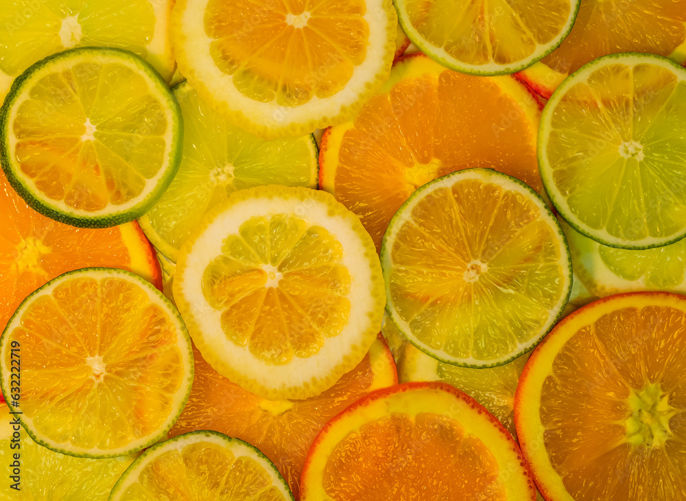 Obraz premium Slices of orange, lemon, lime, natural background, fresh fruits, vitamins, healthy food, top view.