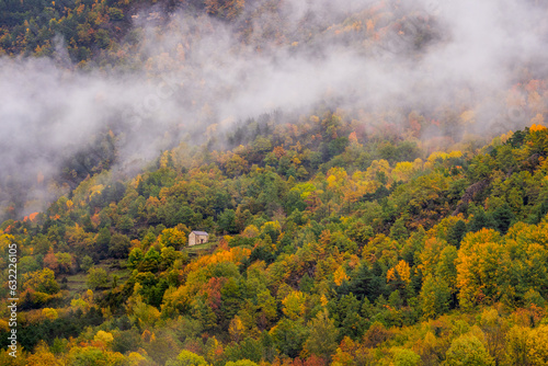 House on the side of a mountain during autumn, Ordesa National Park (Spain).