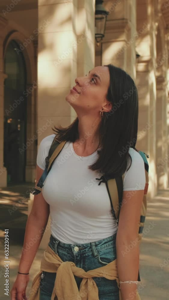 Traveler woman walking down the street looking around Traveler woman walking down the street looking around