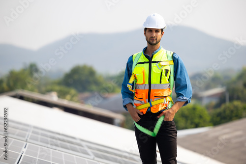 Portrait hispanic latin man worker. electrical engineering man Installing Solar Cell panels on Roof. Solar energy clean and green alternative energy concept. © NVB Stocker