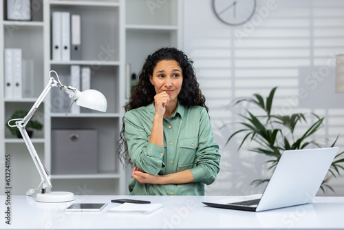 Portrait of serious thinking woman at workplace inside home office  business woman thinking about solving difficult financial problems.