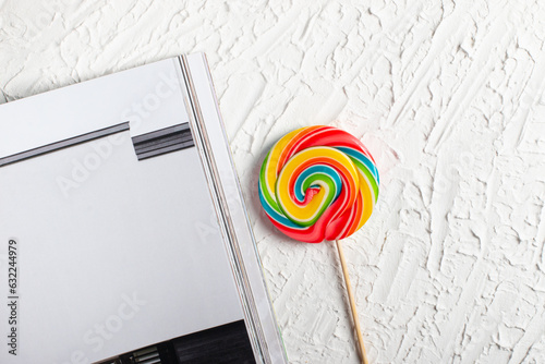 Bright multicolored lollipop on a white background. top view. sweets for the holiday. There is an empty space on the right for placing text or something else.