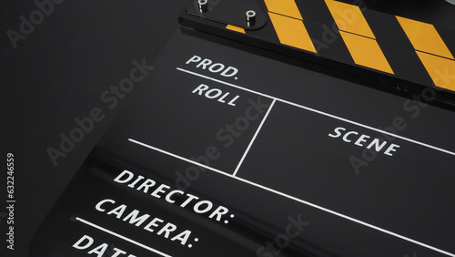 Yellow and black Clapper board or movie slate on black background. It use in movie and video production industry. photo