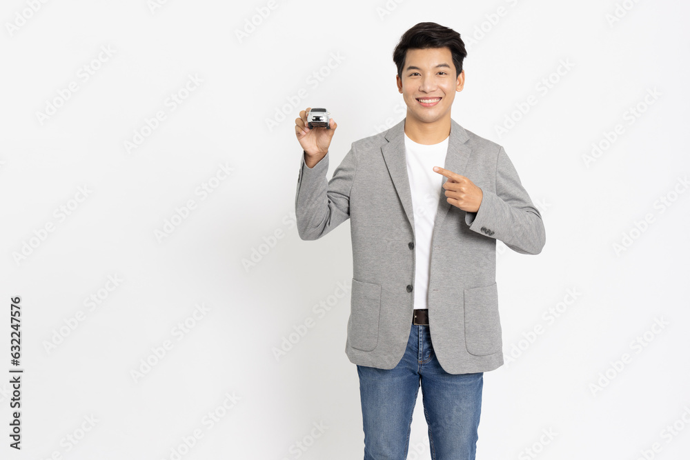 Young Asian businessman holding car model isolated on white background, Car Insurance concept Young Asian businessman holding car model isolated on white background, Car Insurance concept