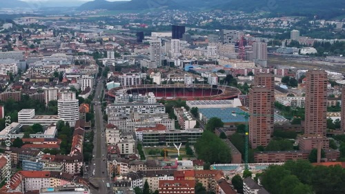 Elevated slide and pan shot of Letzigrund football and athletic stadium surrounded by apartment houses in city. Zurich, Switzerland photo