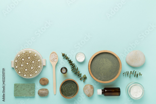 Composition with cosmetic clay and spa products on color background, top view