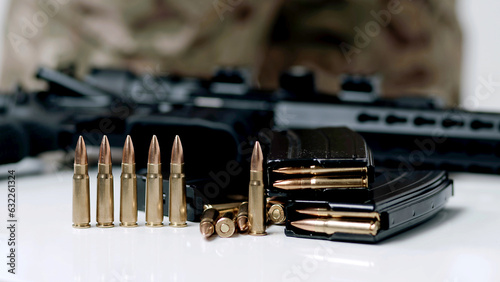 Photo Hand taking ammo, bullets 762 caliber for ak47, gun crime military target war bu