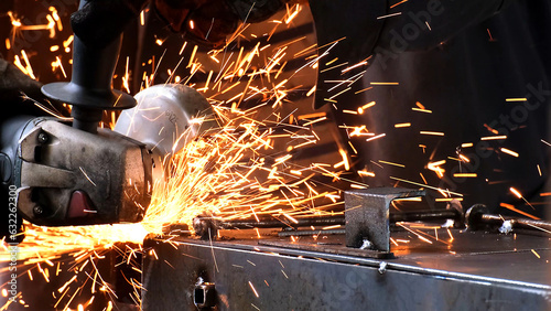 Factory worker welds metal. The man is welding. Welding with argon or electrode, using a welding machine. An industrial enterprise producing metal structures. Sparks and flashes fly. 