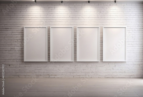 A white brick wall with four empty picture frames