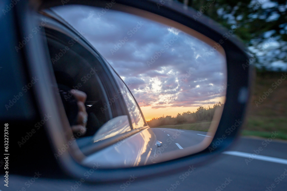 Sunset in car mirror, reflection from the nature