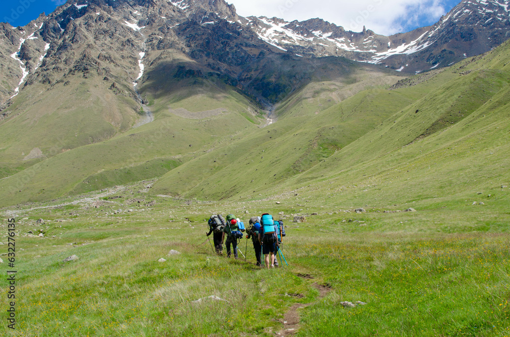a group of tourists is walking along a mountain trail.hiking.people in the mountains.