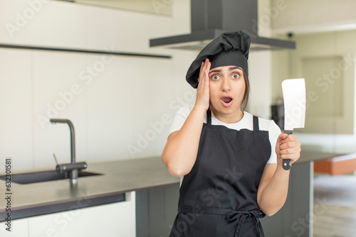 young woman feeling extremely shocked and surprised. chef concept