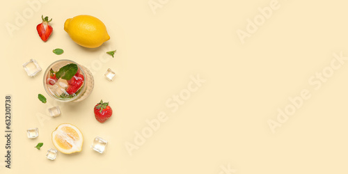 Glass of fresh strawberry lemonade on light background with space for text