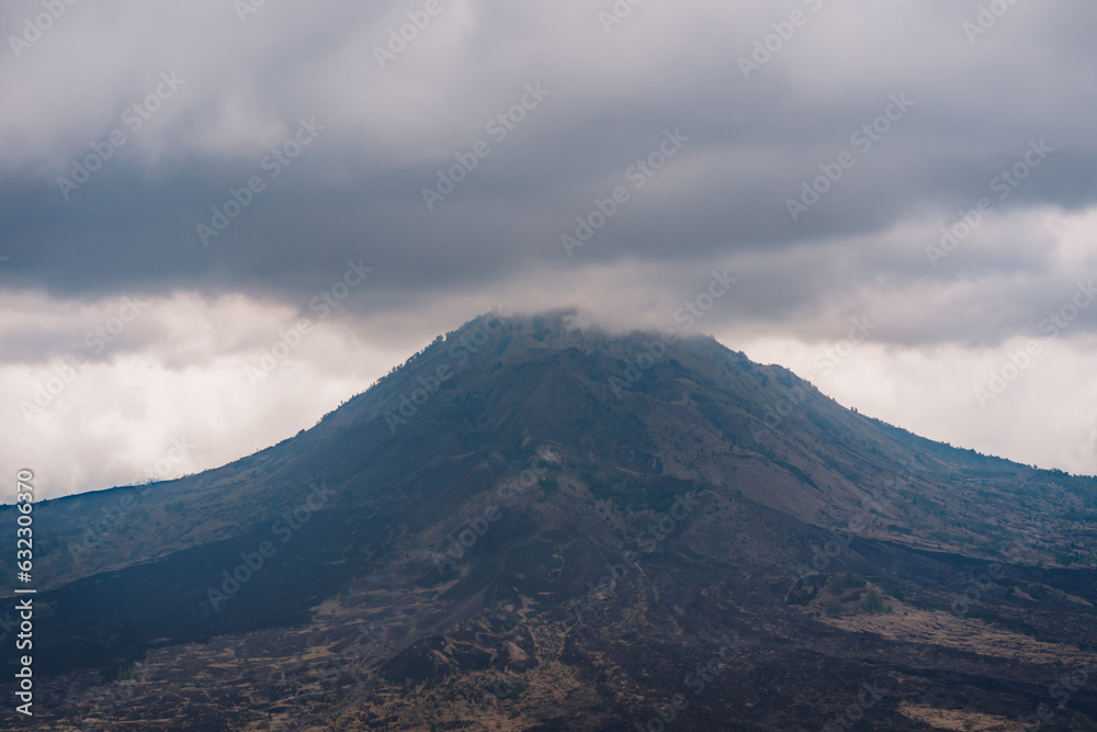 Landscape view of Batur mountain top in clouds. Morning mysterious mist at volcano Batur