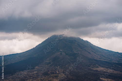 Landscape view of Batur mountain top in clouds. Morning mysterious mist at volcano Batur