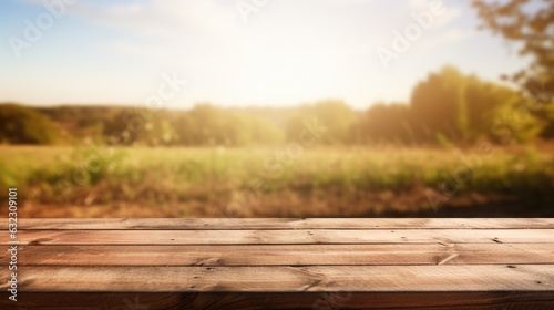 Mock-up with empty wood table top on blurred wheat landscape background
