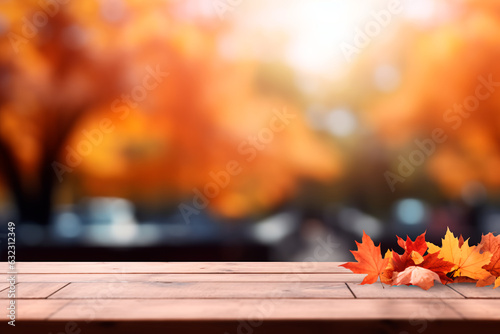 The empty wooden table top with blur background of the autumn landscape of the park