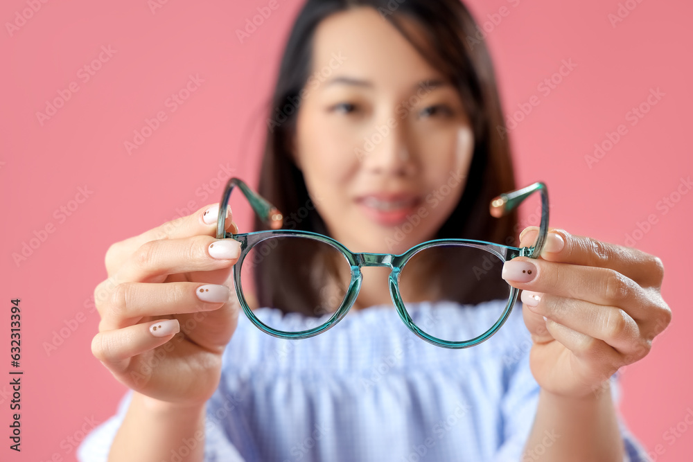 Beautiful Asian woman with stylish eyeglasses on pink background, closeup Beautiful Asian woman with stylish eyeglasses on pink background, closeup