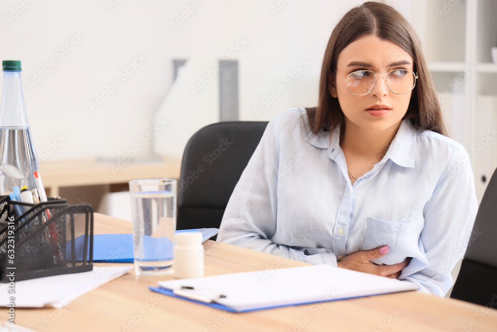 Young businesswoman having heart attack in office Young businesswoman having heart attack in office