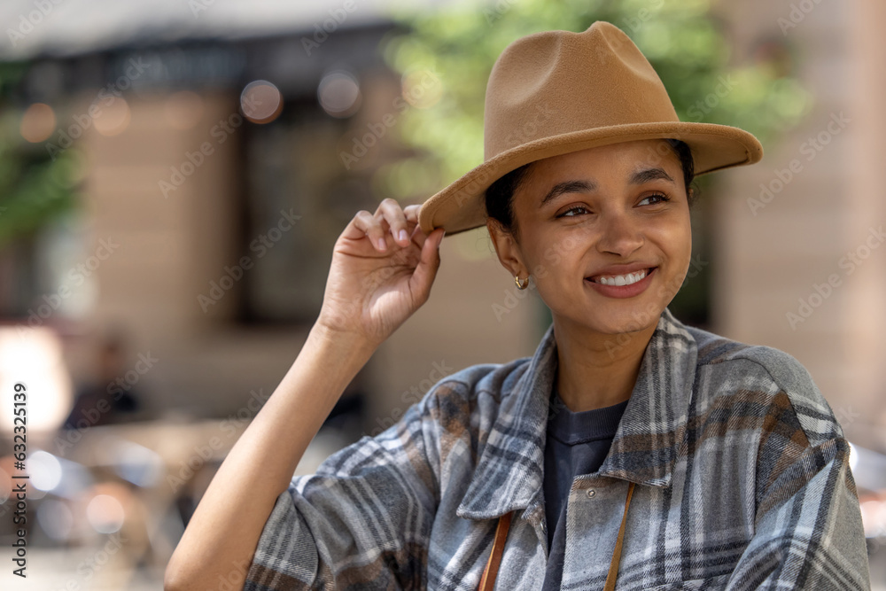 Pretty smiling girl in a straw hat