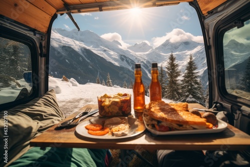 interior furgoneta camperizada con comida mirando las montañas nevadas, camping en la nieve, desayunando en la montaña con vistas a la nieve photo