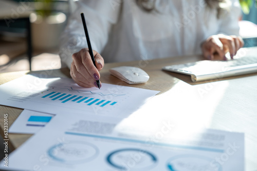 Close up of a woman making notes and working with schemes photo