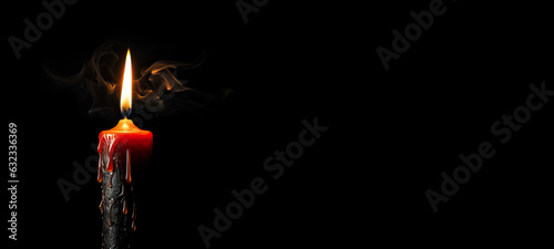 Candle with Smoke Burning in Dark Against Black Background