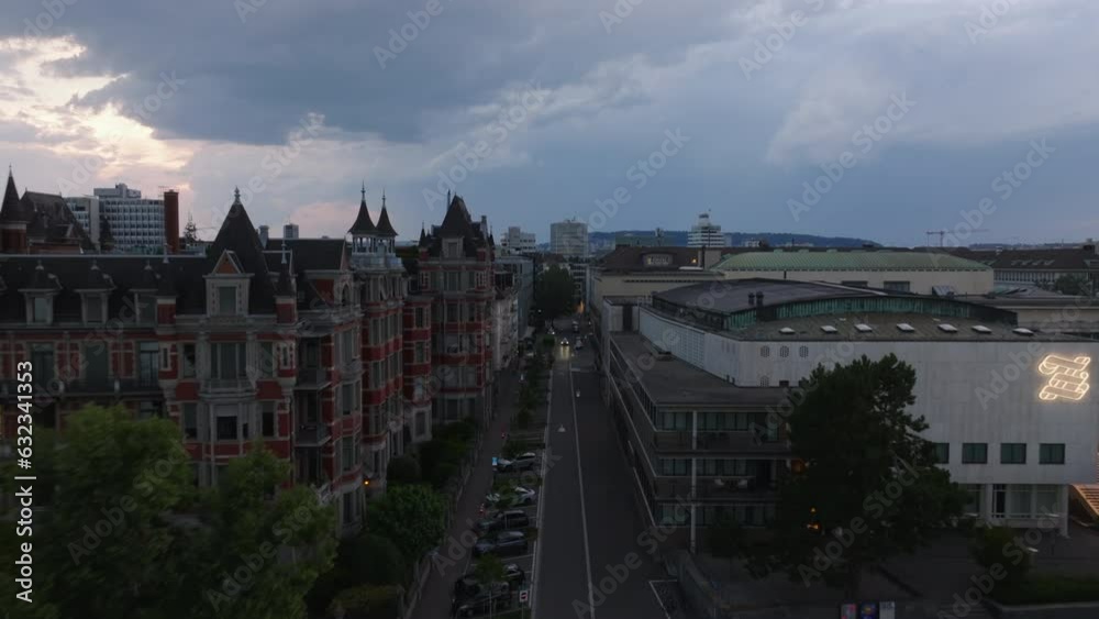 Backwards reveal of old buildings in urban borough and waterfront with moored small sailboats. Zurich, Switzerland Backwards reveal of old buildings in urban borough and waterfront with moored small sailboats. Zurich, Switzerland