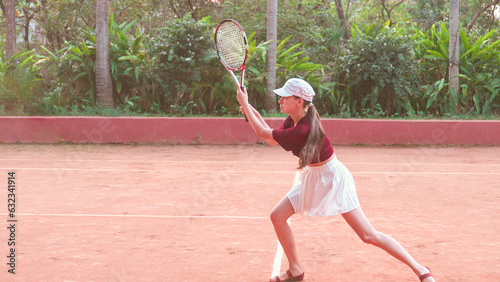 young woman returning a serve in tennis © Maksim