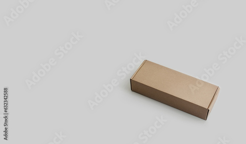 A rectangular cardboard parcel box on a light background. No people  no text. Copy space. Sustainability. Minimalism