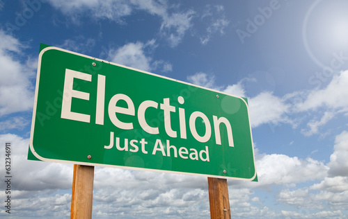 Election Just Ahead Green Road Sign Over Clouds and Blue Sky.