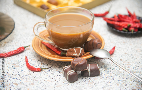 cup of hot drink with chili peppers and chocolate sweets