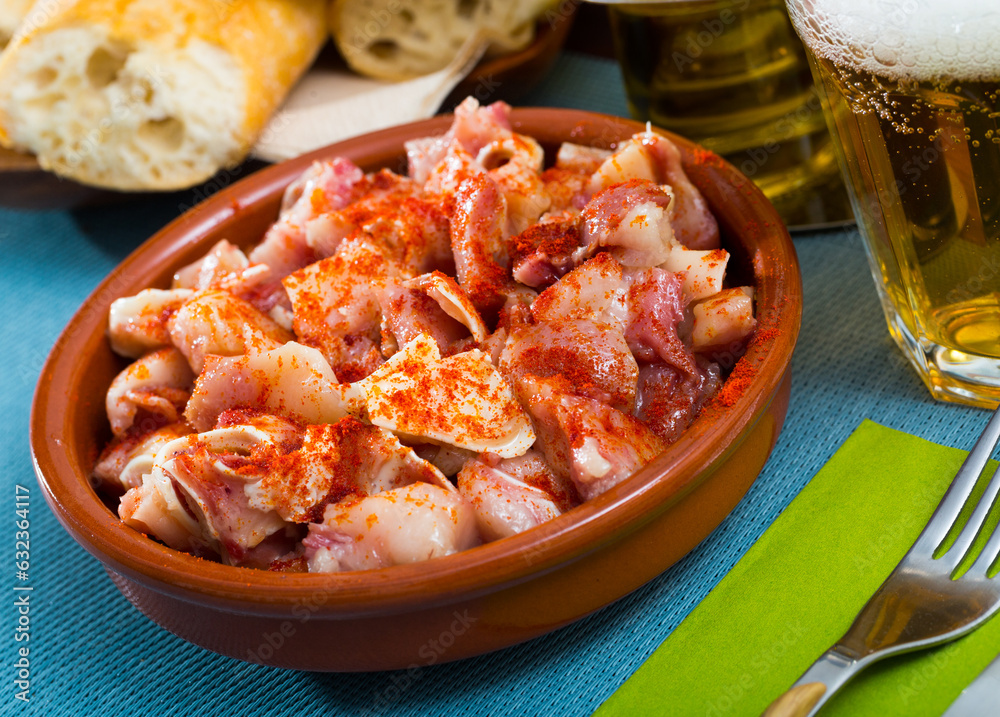 Typical Spanish tapas. Roasted cut pig ears served with smoke paprika