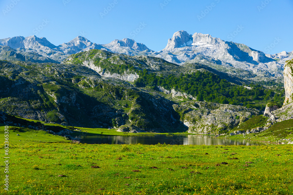 Picturesque rocky landscape with mountain range above lake of Covadonga in summer day, Spain ..