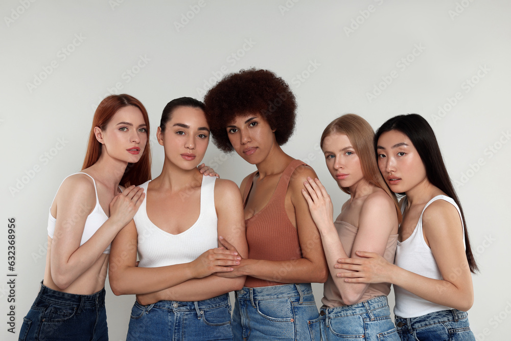 Portrait of beautiful young women on light grey background Portrait of beautiful young women on light grey background