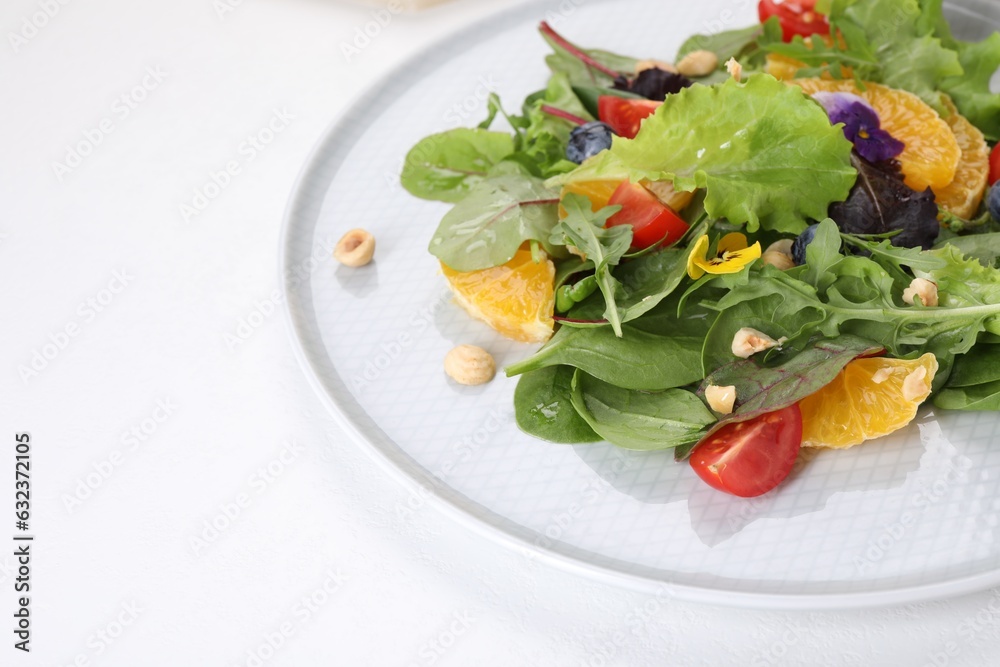 Delicious salad with tomatoes and orange slices on white table, space for text Delicious salad with tomatoes and orange slices on white table, space for text