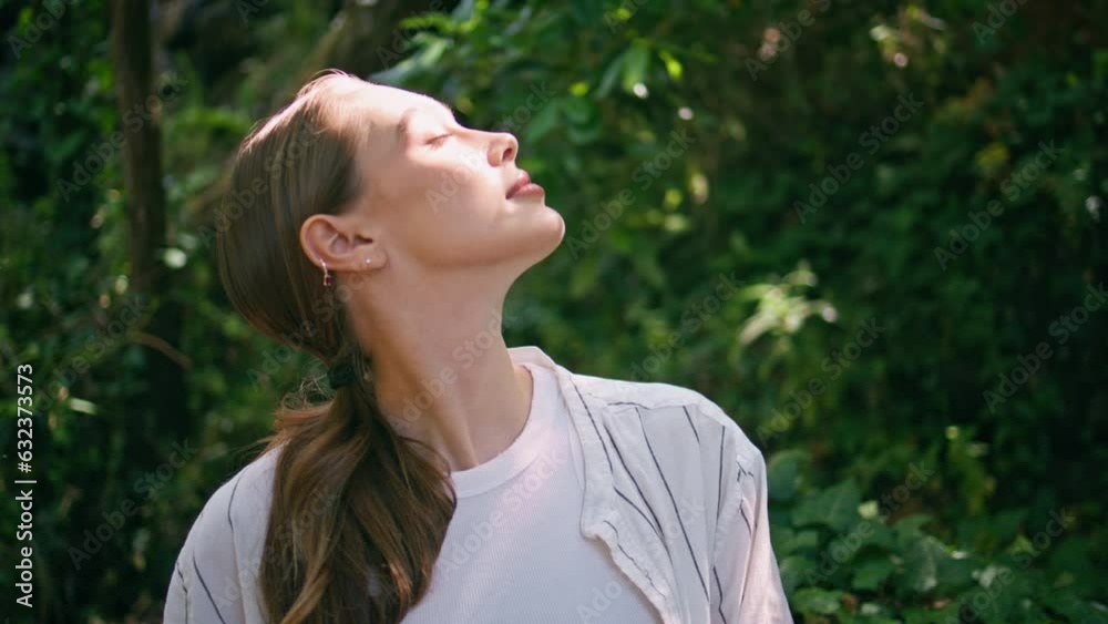 Tranquil woman enjoy sunlight sitting green forest close up. Lady relaxing park Tranquil woman enjoy sunlight sitting green forest close up. Lady relaxing park