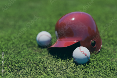 A background with a baseball and a baseball helmet on the grass ground, 3d rendering