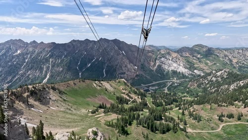 Summer ski tram recreation snowbird mountain Utah descending. Summer and winter all season mountain resort. Vacation nature family fun destination. Recreation rides. photo